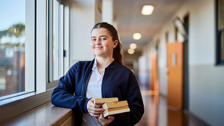 a high school student holding books